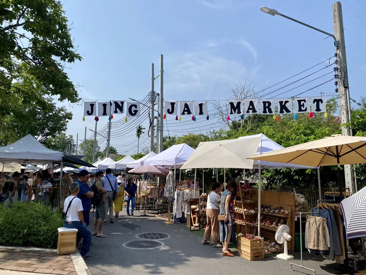 Jing Jai Market letters hanging above the market stand