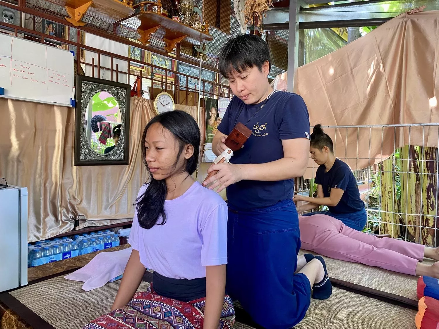 Thai lady receiving Tok Seng Wooden Stick Massage
