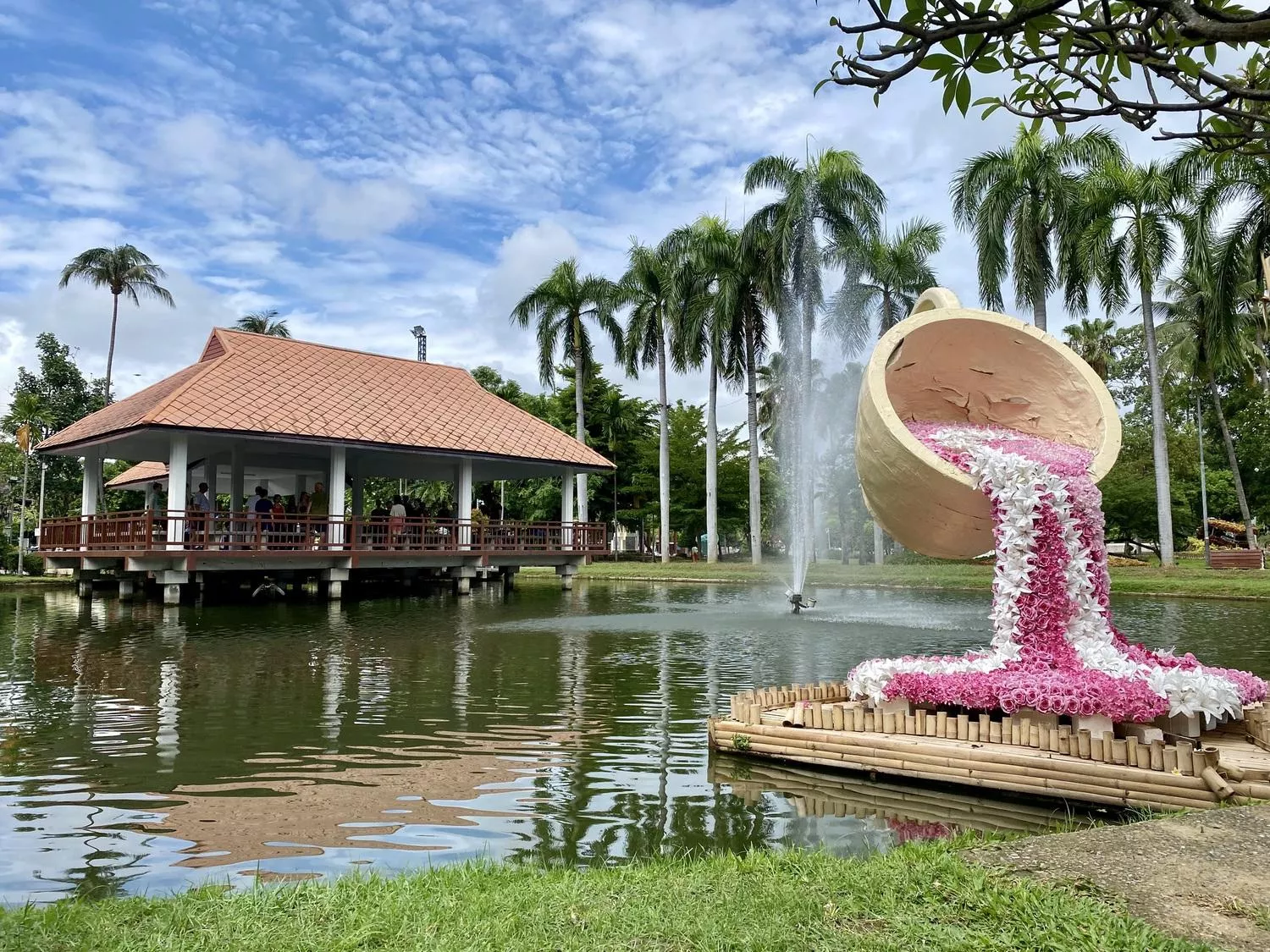 View on a pavilion in a pond, a fountain and a tea cup as art decoration