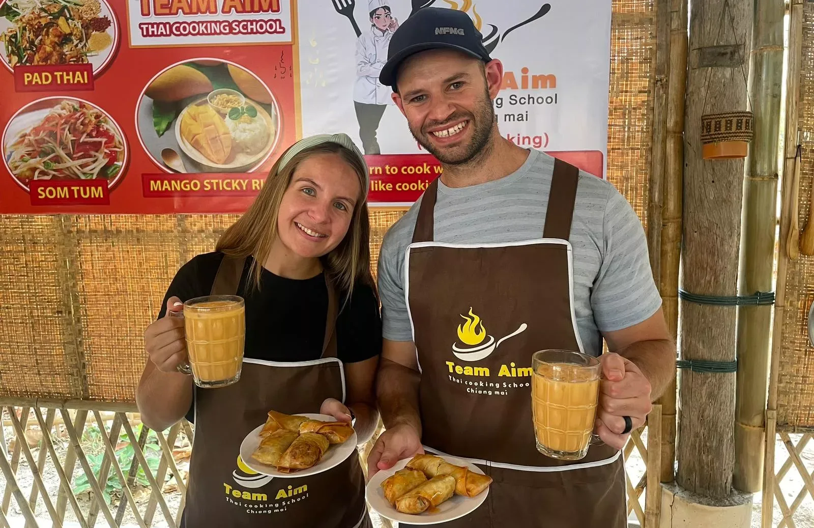 Western couple showing their cooked Thai food