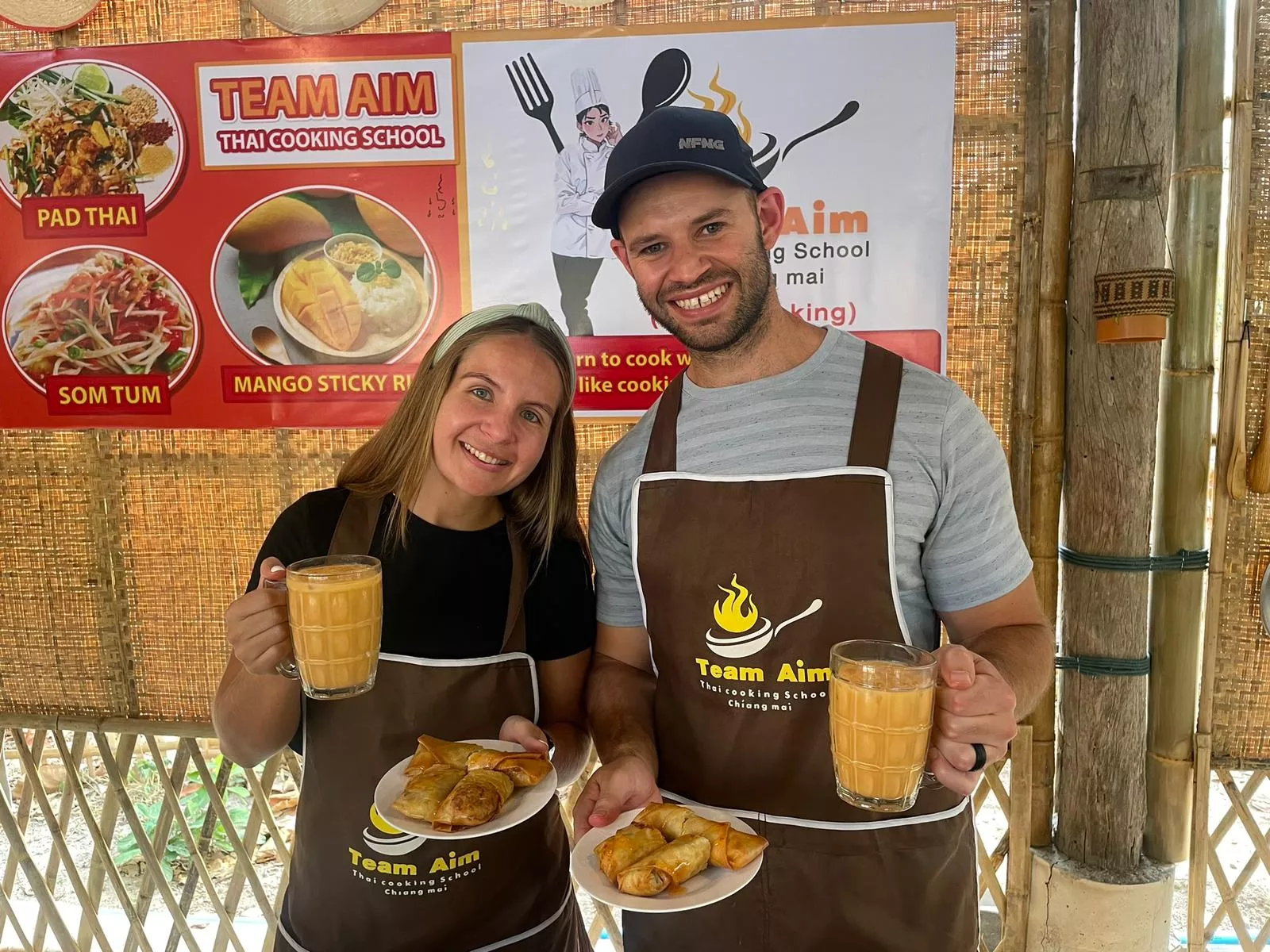 Western couple showing their cooked Thai food